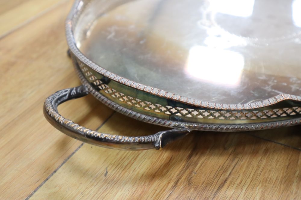 An oval two handled plated tray on lion paw feet, and another tray, largest 57cm